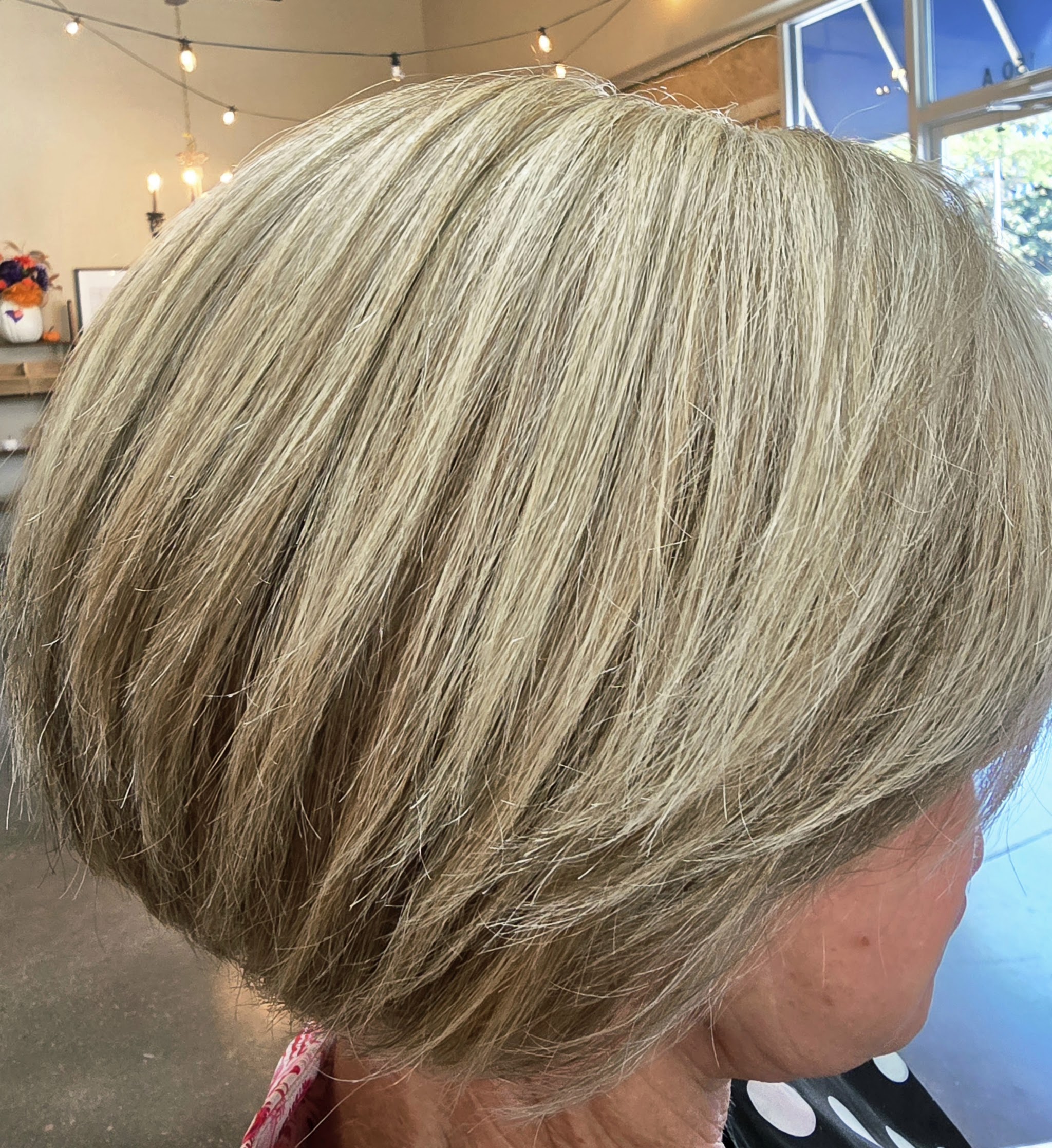 Short ash blonde bob, seen from behind