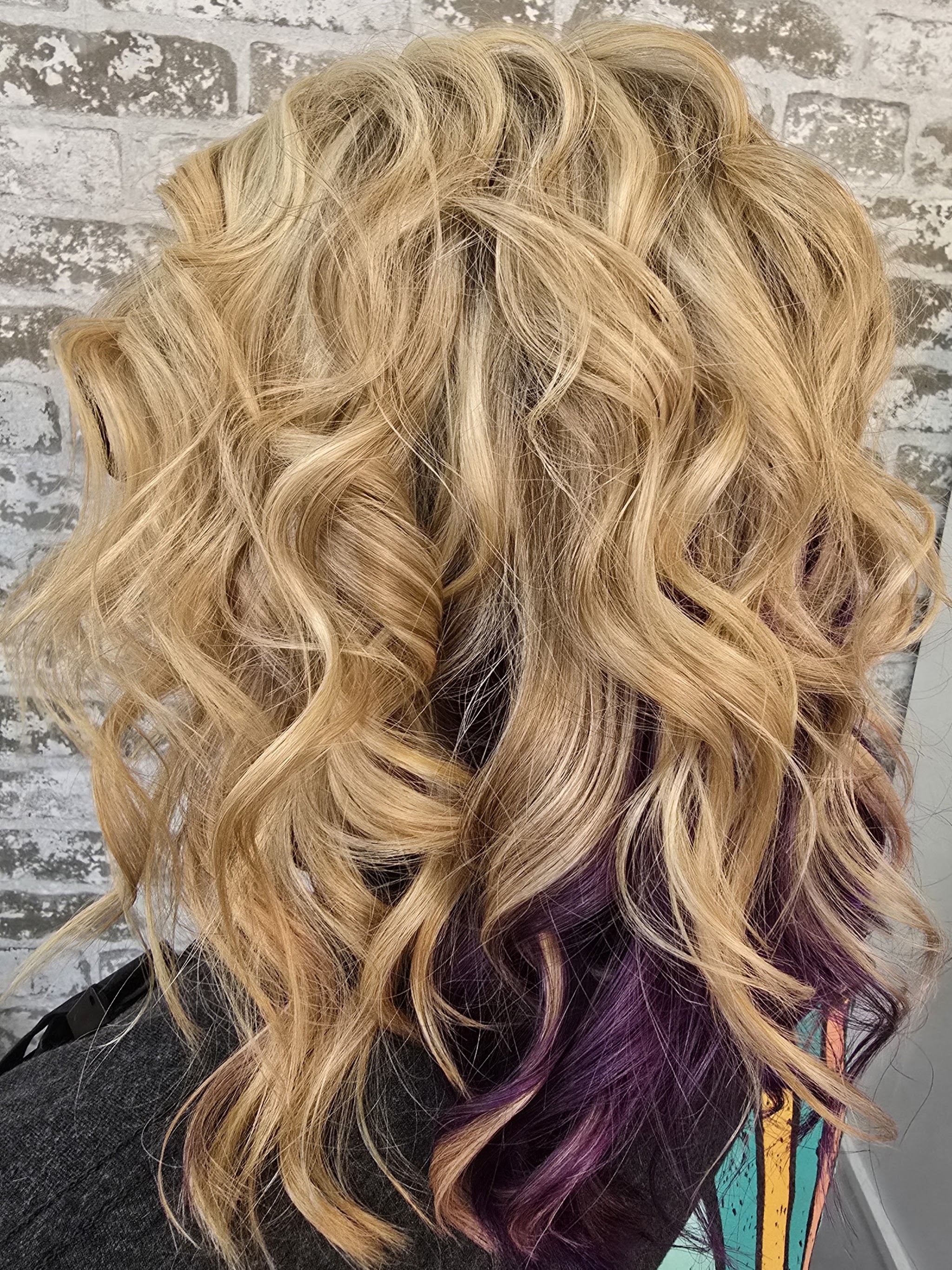 Blonde waves with a purple underlayer, done at The Hair Society